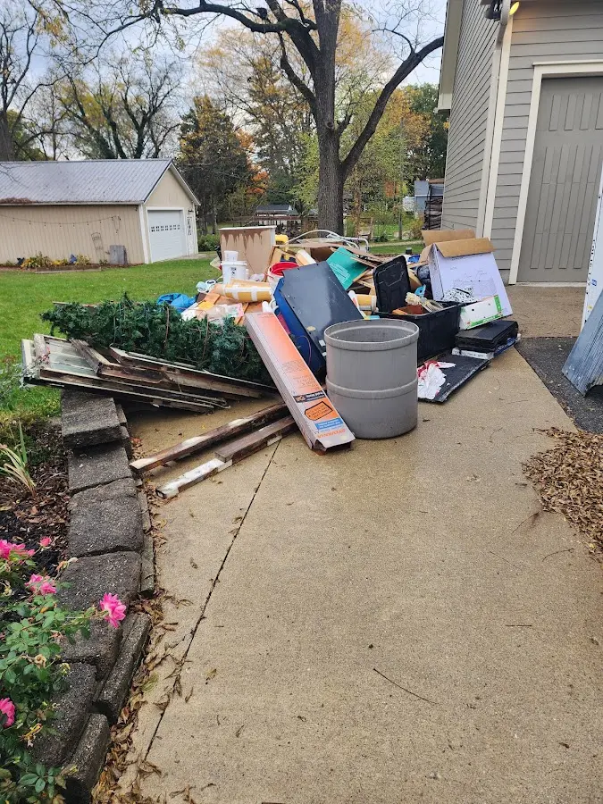 Dumpster being loaded with debris for 12 Yard Dumpster Rental in Corvallis